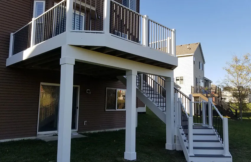 Two-story deck with white square columns and stairs