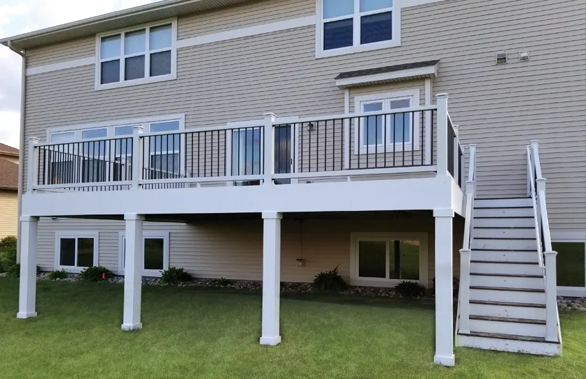 Elevated deck with tapered white columns showing decorative caps and trim details
