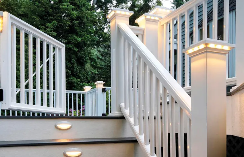 White deck with combination of LED post cap lights on top rails and recessed lights in stair risers