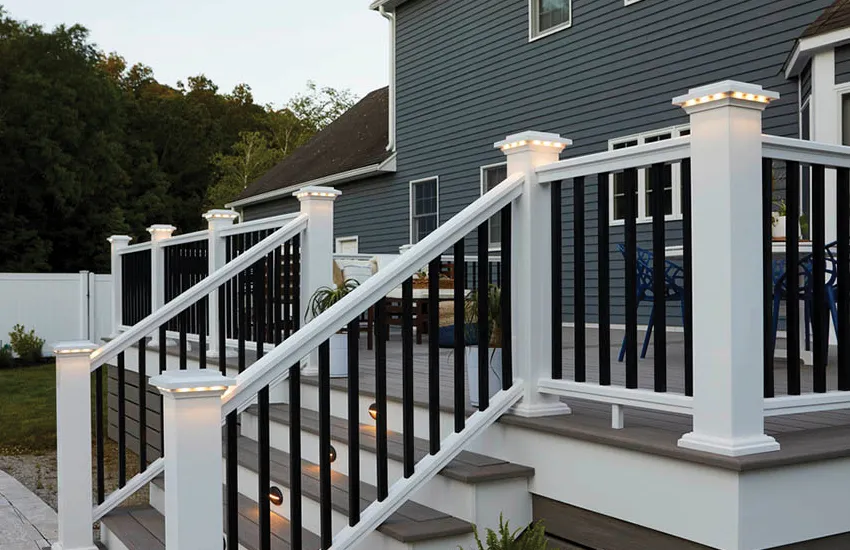 LED post cap lights and stair riser lights on composite deck at dusk