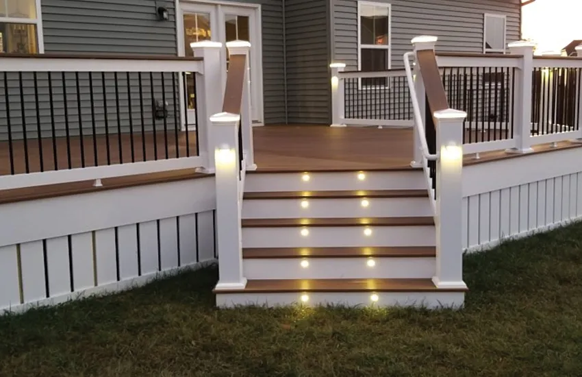 Stair riser lights illuminating deck steps at night