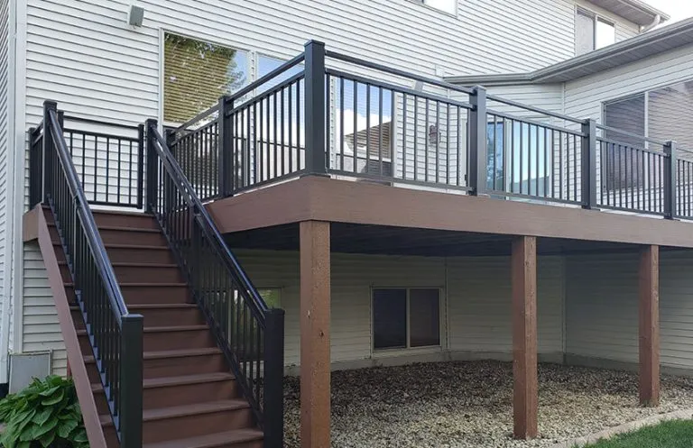 Brown elevated composite deck with black aluminum railings and matching stair railings