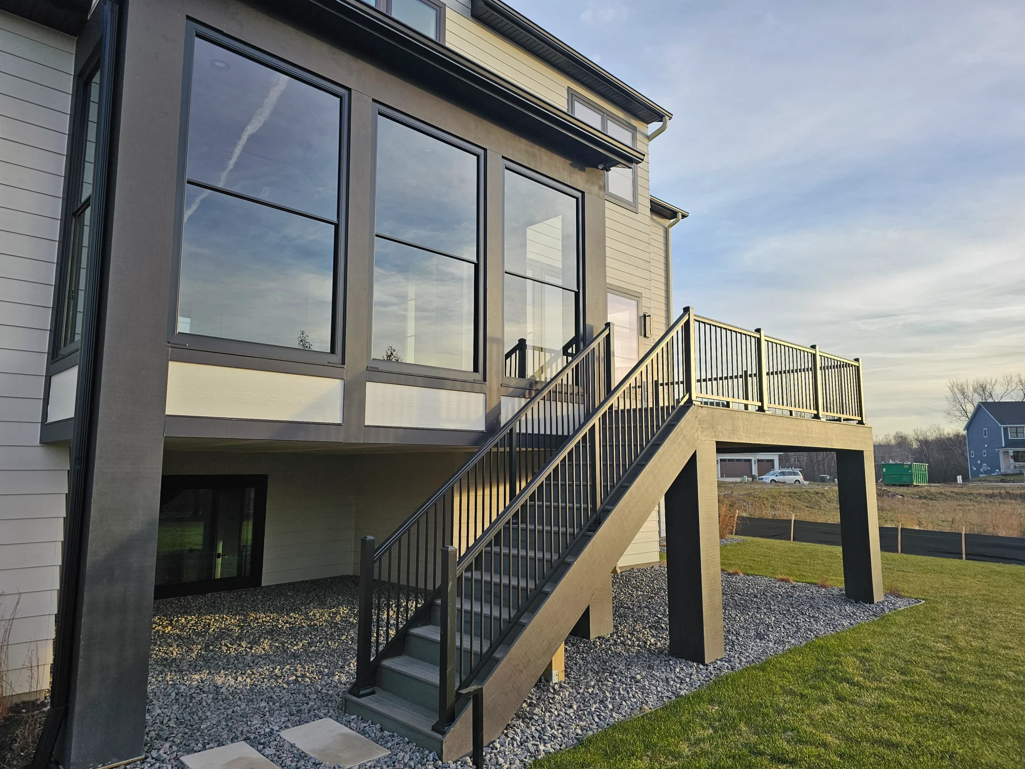 Elevated deck with custom stairs and railings by professional deck contractor